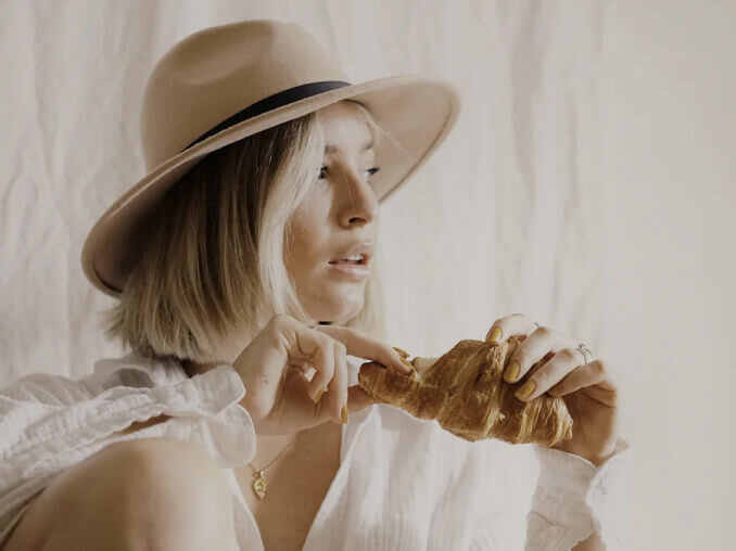 model eating crossiant